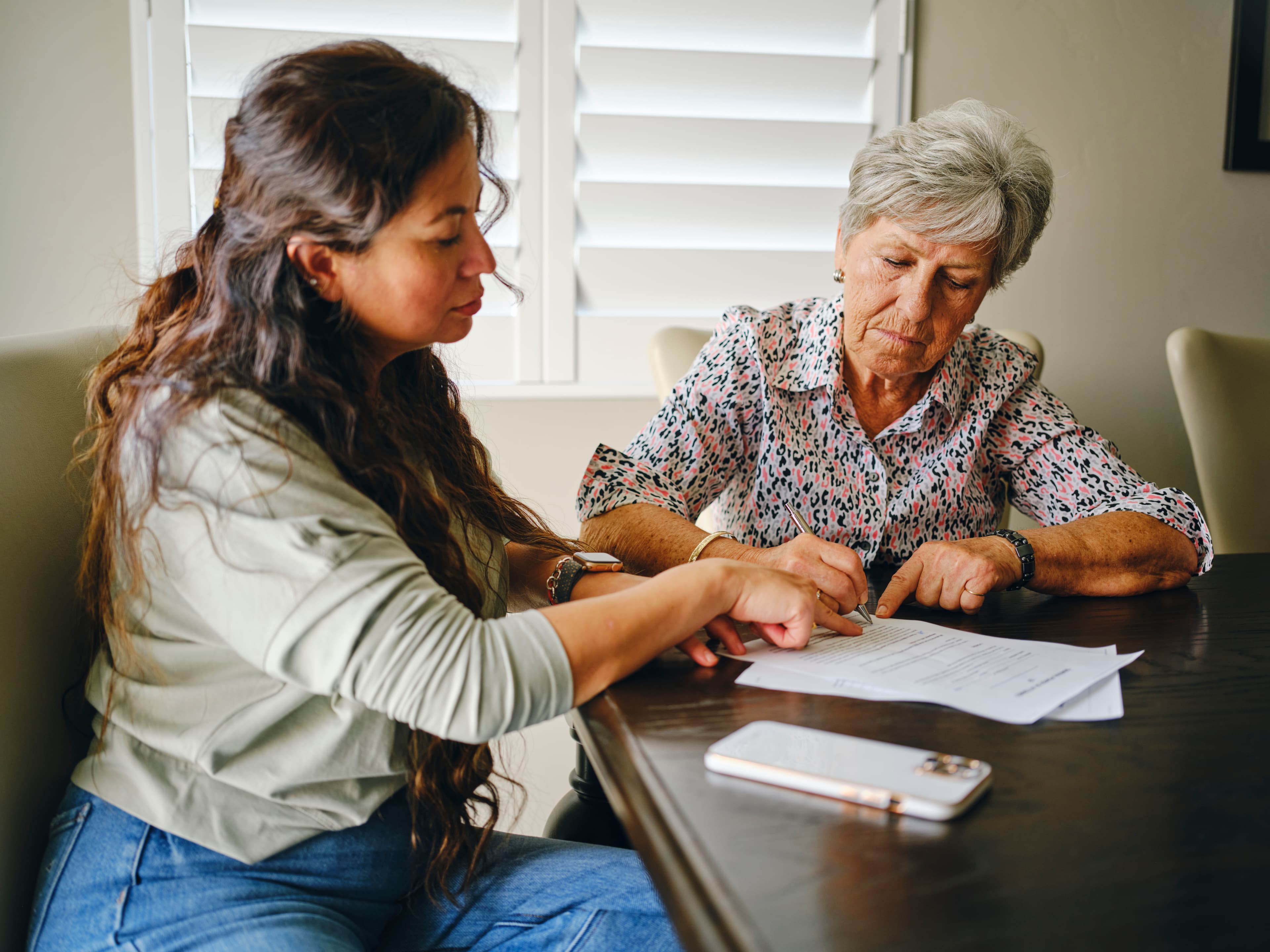 Older couple reviewing legal documents with a solicitor